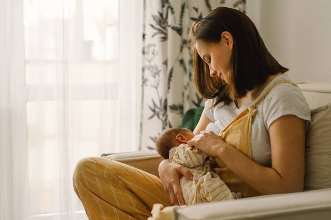 Mom happy with her baby after read the breastfeeding and feeding guide. It shows her comfort and confident.