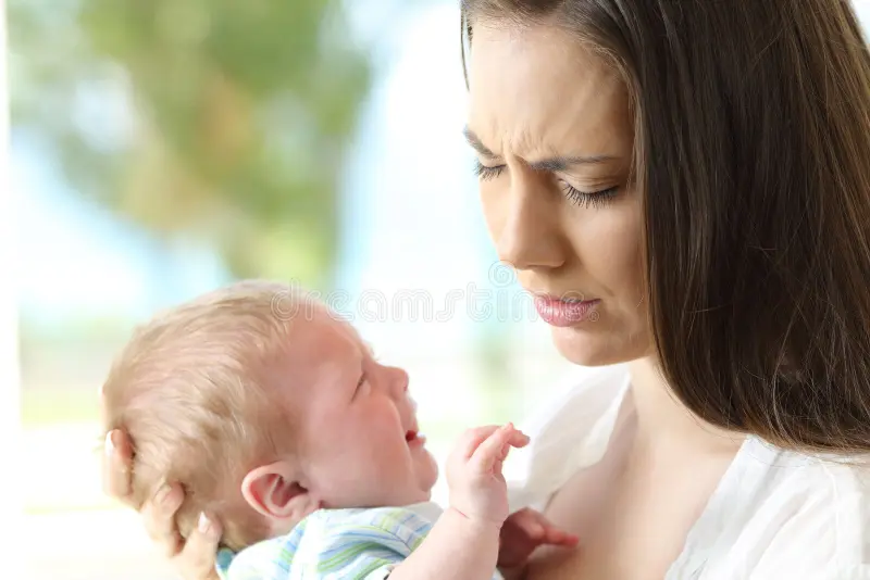 Mom comforting her crying baby with love and patience